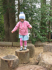 child walking on logs
